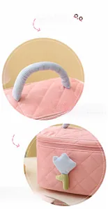 Detail of pink quilted makeup bag with blue corduroy handle and tulip flower decoration