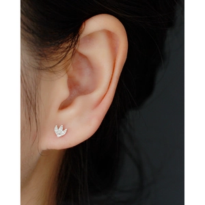Macro view of a S925 sterling silver crown earring with zircon studs on ear lobe