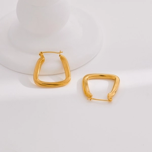 Minimalist gold U-shaped geometric earrings with a polished metallic finish on white