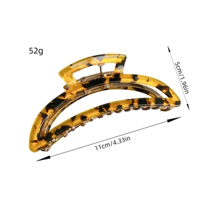 Tortoiseshell acetate hair claw clip with dimensions 11cm by 5cm on white background