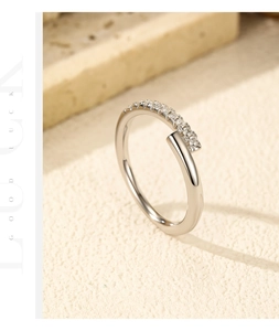Detail of S925 silver open ring with pavé moissanite stones and Good Luck engraving
