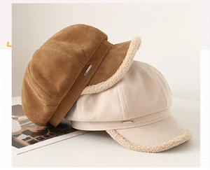 Close-up of suede newsboy caps with shearling trim in caramel brown and oatmeal beige