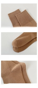Detail of elastic cuff, reinforced toe, and 3D heel on brown knit crew socks
