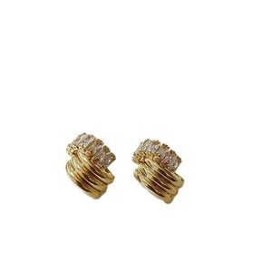Elegant gold zircon stud earrings with vintage layered design on a clean white background