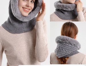 Detail of grey cable-knit winter hooded scarf with thick faux fur lining and texture
