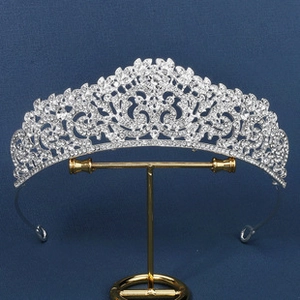 Detailed view of silver bridal crown with sparkling rhinestones on golden stand