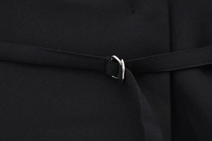 Detail of elegant black blazer woven fabric with decorative silver metal ring buckle