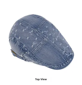 Top view of blue washed denim newsboy cap featuring quilted diamond patterns and metal buckle