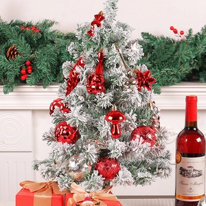 Christmas tree with red and silver ornaments and white snow effect in a cozy home setting