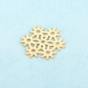 Golden stainless steel snowflake pendant with gear gear design on light blue background