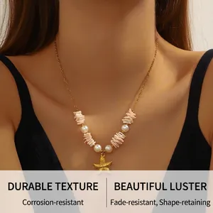 Detail of bohemian gold starfish pendant necklace with pearls and pink coral beads