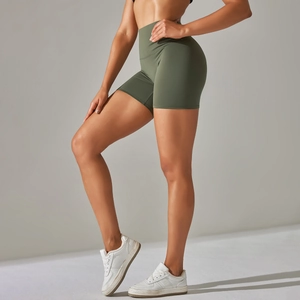 Detail view of high-waisted olive green yoga shorts with peach-lift and seamless contour