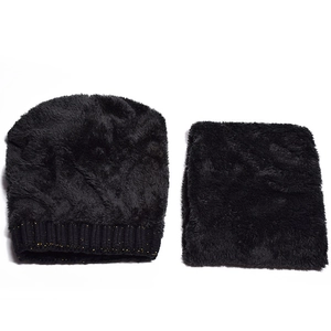 Flat lay of black winter knit hat and neck warmer set with faux fur and gold glitter details