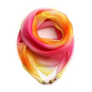 Detail showing gradient silk scarf with gold magnetic clasp and soft fabric texture