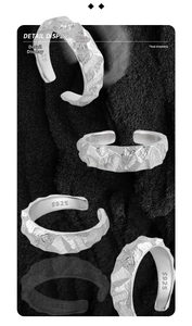 Detail view of the hammered rock texture and S925 silver engraving on this open ring