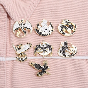 Set of 7 black and white enamel pins with gold mythical creatures on pink denim