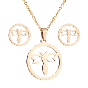 Detail of gold necklace and dragonfly earrings set with hollow circular pattern