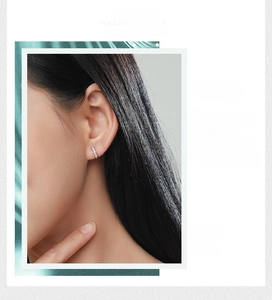 Detail of minimalist S925 silver hoop earrings with cubic zirconia worn by model