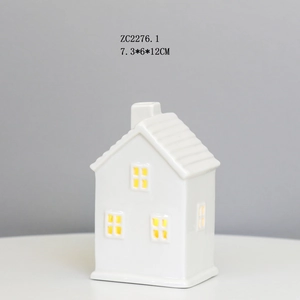 Detail view of a white ceramic house night light with 7.3x6x12cm size dimensions