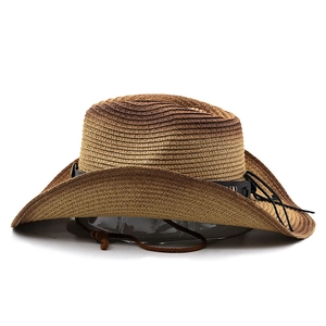 Detail of straw cowboy hat featuring gradient brown weave and studded leather band