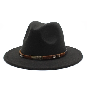 Classic black wool fedora hat with brown band and vintage metal badge on white background