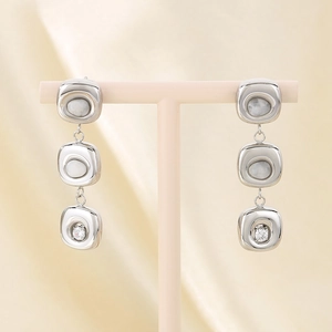 Detail of silver drop earrings with white marble stones and round cubic zirconia