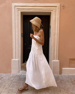 White pleated maxi dress with thin straps and square neck styled for vacation