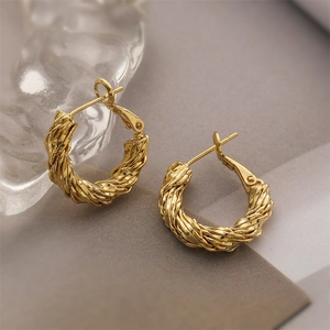 Minimalist gold-plated C-shaped metal hoop earrings with elegant twisted texture design