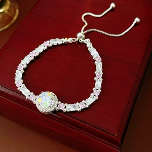 Detail of adjustable silver bracelet with pink and white cubic zirconia on jewelry box