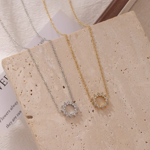 Sparkling sunburst zircon round pendant necklace in gold and silver set on stone