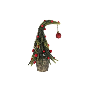 Mini artificial snow-covered Christmas tree with red berries and a festive shiny bauble
