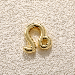 Macro view of a 18K gold plated chubby Leo zodiac sign charm with high polish finish