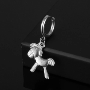 Macro view of a silver titanium steel earring with a 3D horse-shaped charm
