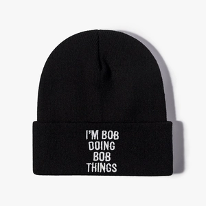 Black knit beanie hat with white 'I'M BOB DOING BOB THINGS' embroidery on the cuff