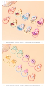 Detailed view of colorful resin cartoon mermaid and starfish ocean themed hair elastics
