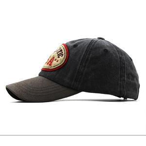 Detail of vintage washed canvas baseball cap with suede brim and USA embroidery