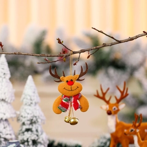 Close-up of a felt Christmas reindeer ornament with red nose and golden bells on a tree