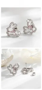 Detailed view of hollow bunny earrings with sparkling zircon and pink bow accents