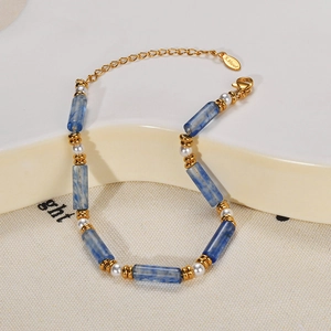 Detail of gold stainless steel bracelet with blue marble beads and natural pearls