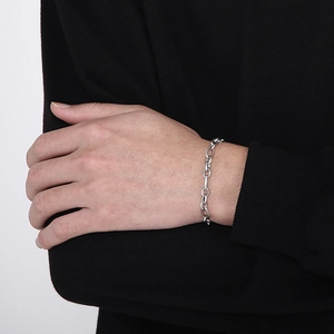 Detail of silver 6mm O-chain bracelet on wrist featuring a minimalist industrial design