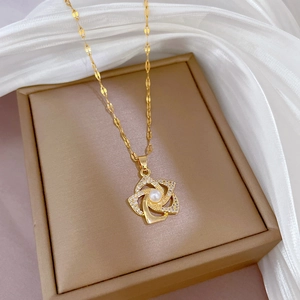 Titanium steel rotating flower necklace with zircon and pearl on silk background