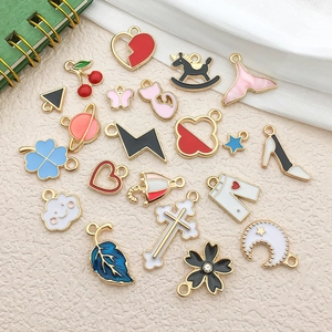 Macro shot of colorful enamel heart and clover charms for DIY jewelry making accessories