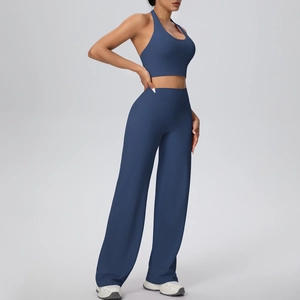 Detail of navy blue high-waist wide-leg yoga pants and halter neck sports bra set