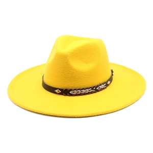 Detail of yellow wool fedora hat with faux leather band and metallic rivet accents