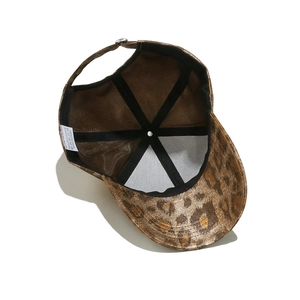 Detail view of polyester leopard baseball cap with black sweatband and wash label