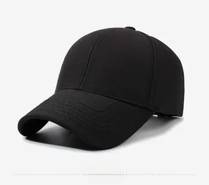 Side view of black twill cotton baseball cap with a square metal emblem and stitched brim