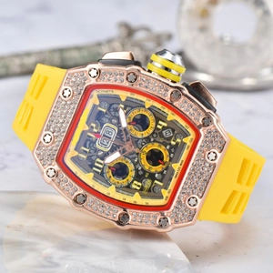 Detailed close-up of iced-out tonneau skeleton watch with yellow rubber strap