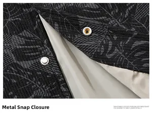 Detail of metal snap fasteners on high-quality dark floral corduroy jacket fabric