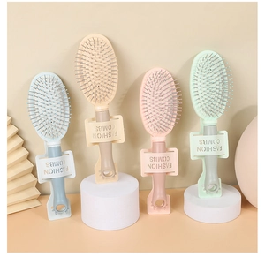 Macro detail of portable hair brushes in pastel colors with soft air cushion bristles