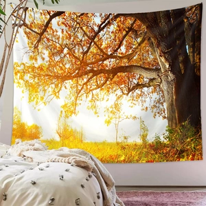 Detail of autumn forest tapestry hanging in bedroom showing golden trees and sunlight